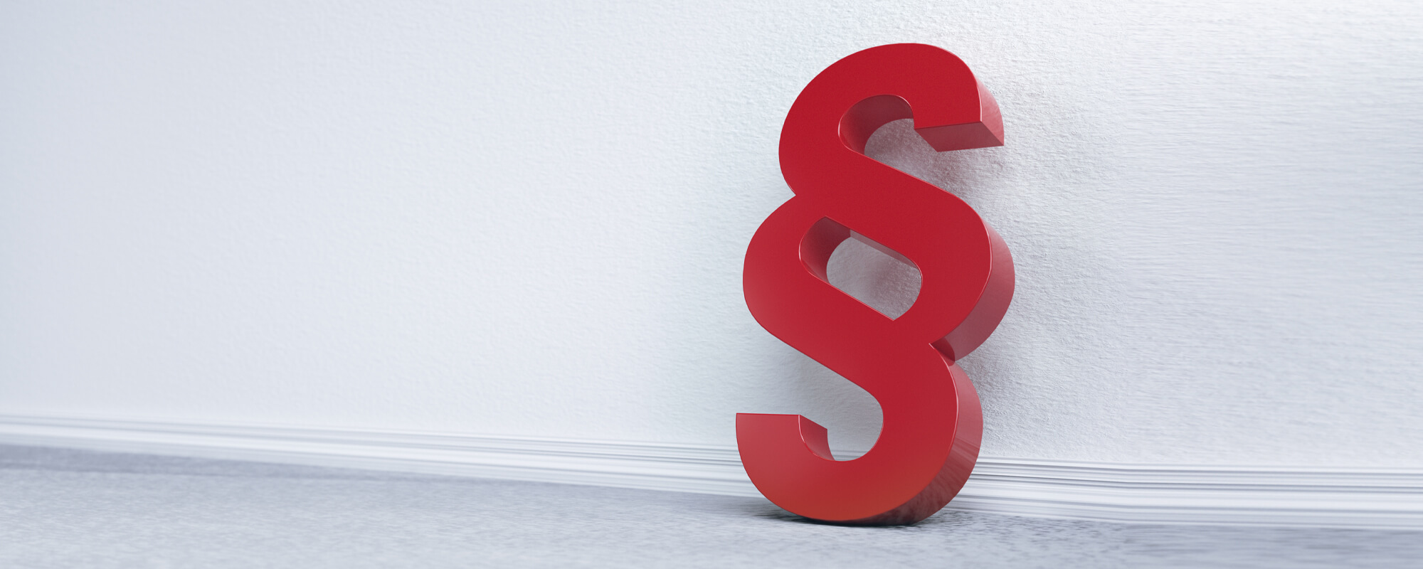 Ein rotes Paragrafenzeichen lehnt an einer Wand | © shutterstock Ein rotes Paragrafenzeichen lehnt an einer Wand.