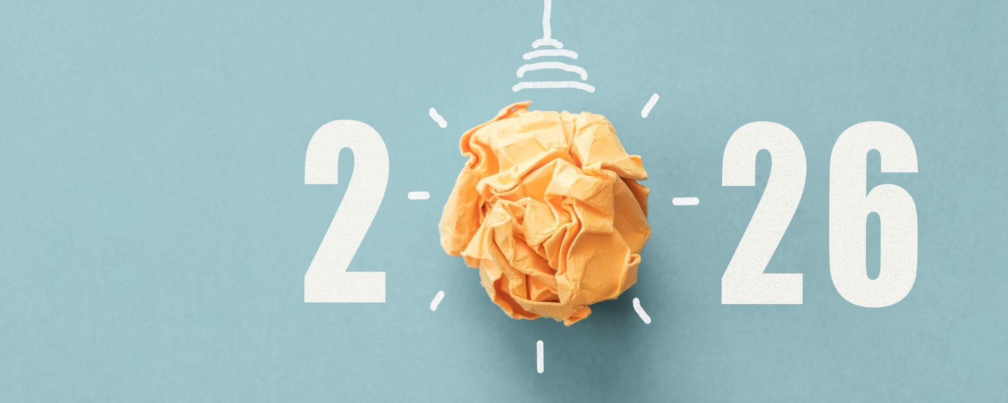 Die Abbildung zeigt die Jahreszahl 2026 in weißer Schrift auf hellblauem Hintergrund. Die Null ist als strahlende Glühbirne dargestellt.
