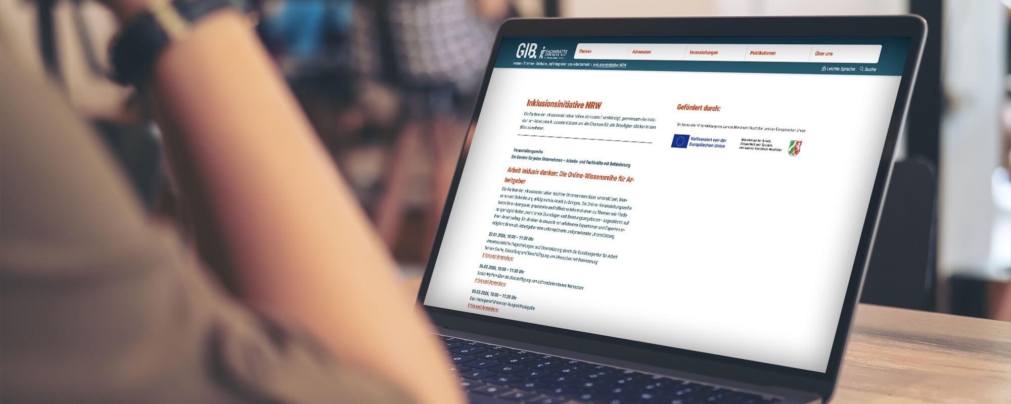 Eine Person sitzt vor einem Laptop