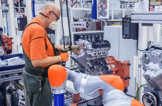 Ford Mitarbeiter arbeitet mit dem Kobot Roboter in der Fertigungshalle.