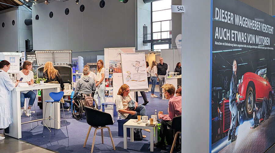 Ein Messestand gefüllt mit Besuchern. 