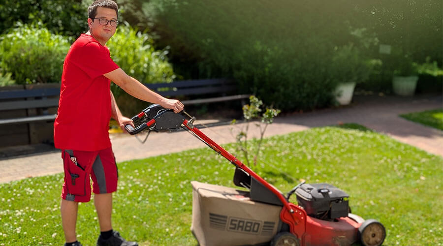 Felix Boos kümmert sich um den Garten | © Monika Kleusch Felix Boos mäht den Rasen.